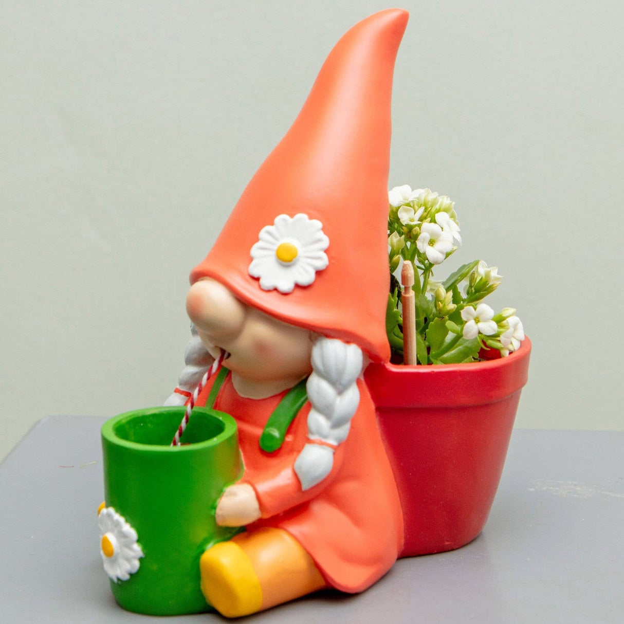 Self-watering gnome plant pot: orange hat, red planter, white flowers