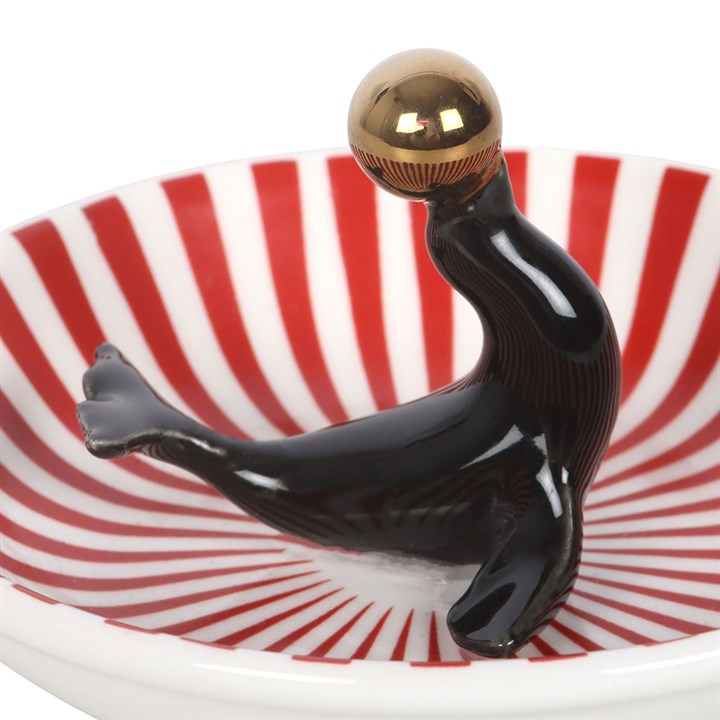 Black seal trinket dish detail: red-striped bowl with gold bulb and raised arms