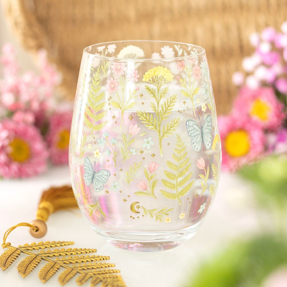 Stemless glass with pastel florals and butterfly, gold crescent accents, clear glass
