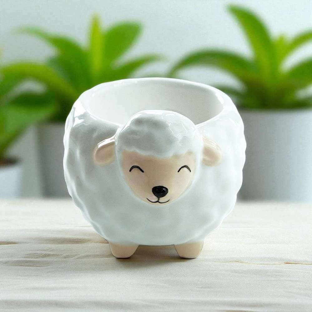 Sheep-shaped ceramic egg cup with painted sheep face, empty, side view