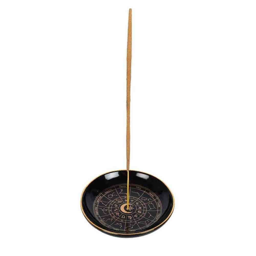 Round black incense holder tray with gold rim and astrology wheel, incense stick included.