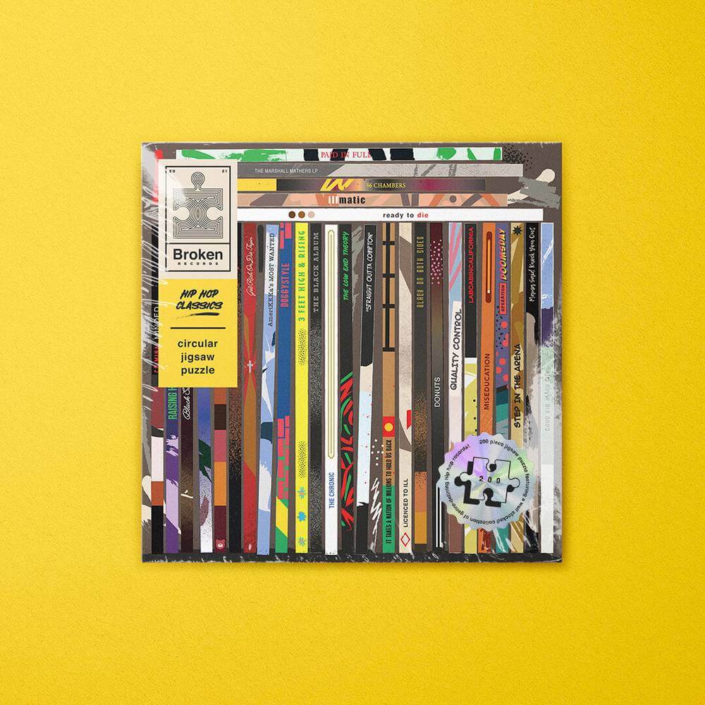 Vinyl-themed circular jigsaw puzzle box with Broken Records text and striped record art