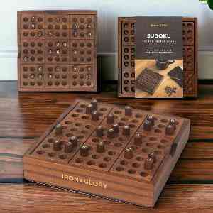 Wooden Sudoku puzzle board set with tray, cover, and wooden pieces on table