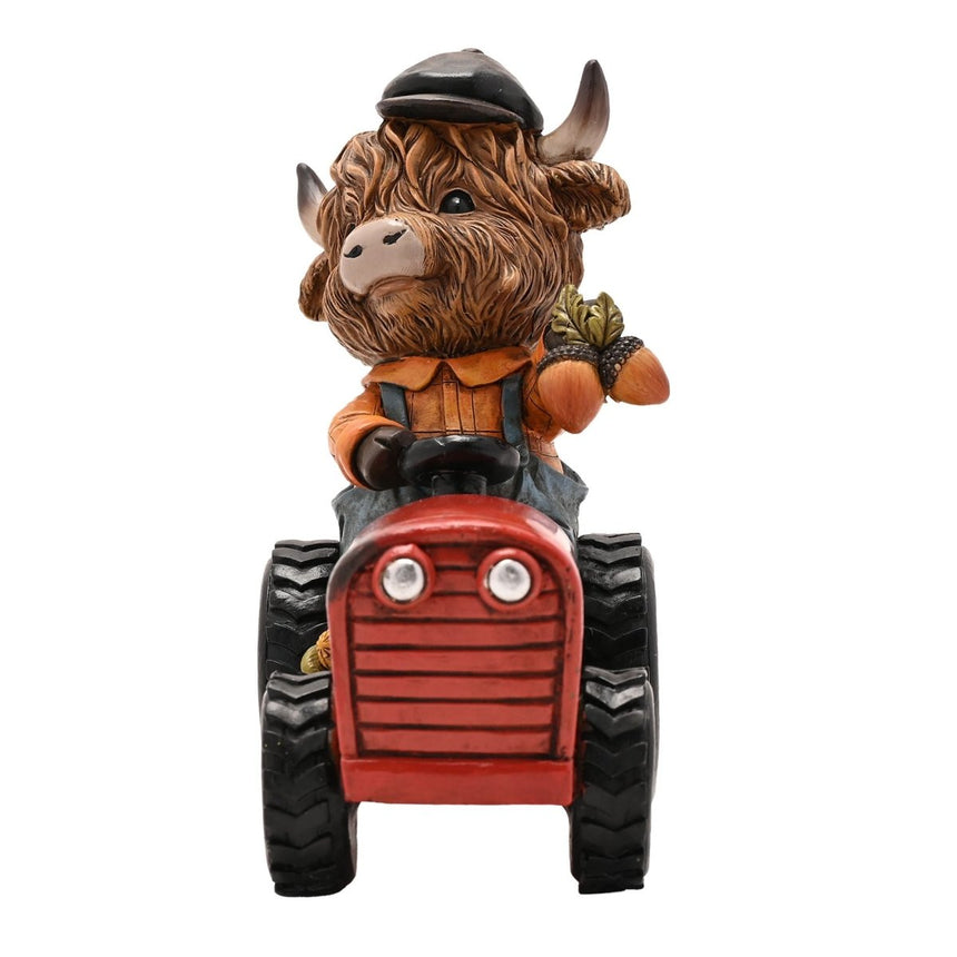 The Fashion Gift Shop: Highland Cow sits happily on a tractor, creating a charming rural scene by Country Living, Animal Ornament