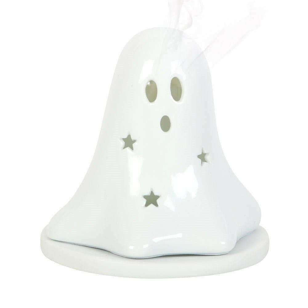 White ceramic ghost tealight holder with hollow face holes and gold star accents