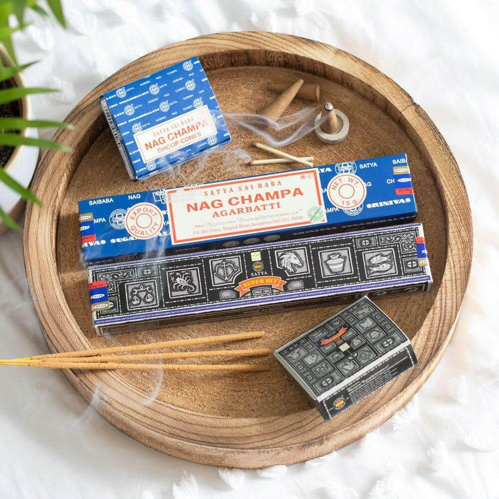 Satya Nag Champa incense sticks in wooden tray with small blue box and pack