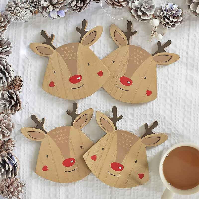 Reindeer coaster set of 4 on table, tan wood faces with dark antlers and red noses