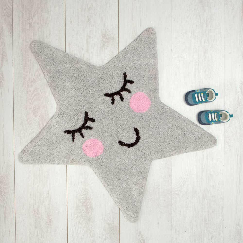 Grey star rug with cartoon eyelash pattern and pink dot cheeks on floor