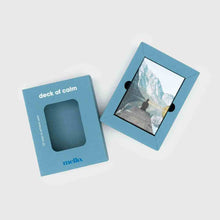 Self-help card deck with blue box and framed landscape card, top view