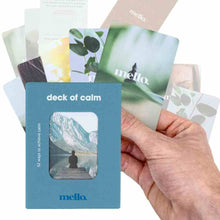 Self-help card deck with blue box and mountain card, hand holding scattered cards