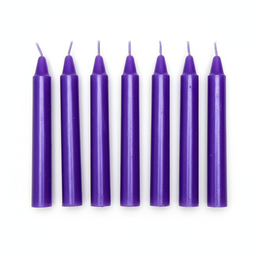Set of six purple taper candles with wicks, arranged in a row