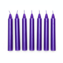 Set of six purple taper candles with wicks, arranged in a row