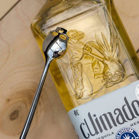 Bottle of Ballarat Gold Liqueur with a spoon on a wooden surface