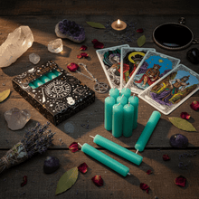 Six teal spell candles standing unlit on a tabletop