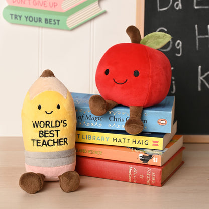 Plush pencil and apple toys: yellow pencil reads "WORLD'S BEST TEACHER", red smiling apple