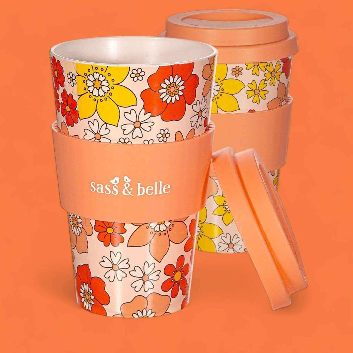 Eco reusable travel mug with orange floral print, clear lid, and attached side handle; Sass & belle