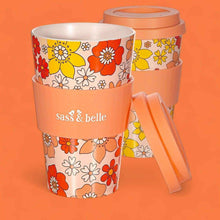 Eco reusable travel mug with orange floral print, clear lid, and attached side handle; Sass & belle