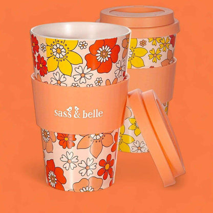 Eco reusable travel mug with orange floral print, clear lid, and attached side handle; Sass & belle