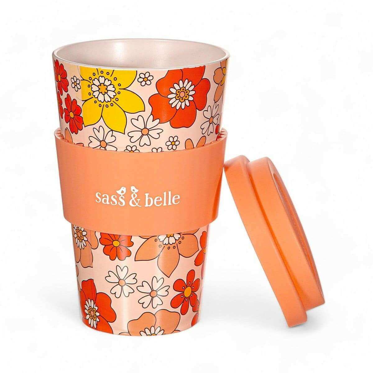 Eco reusable travel mug with orange floral pattern, clear lid, and side carry handle; Sass & belle