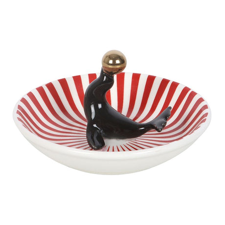 Red-and-white striped trinket dish with glossy black seal standing pose