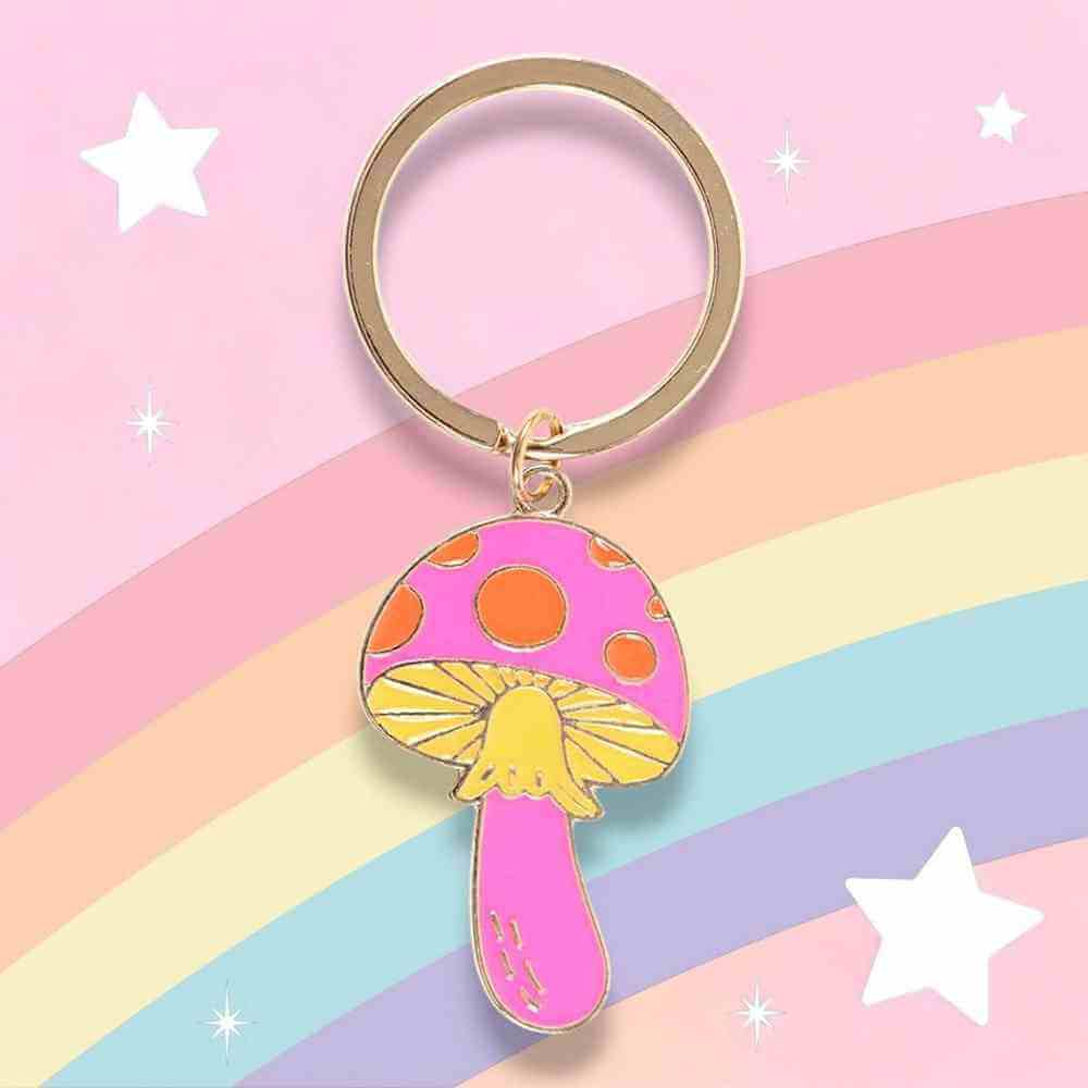 Mushroom keyring charm with orange spots and yellow gills hanging from bronze ring