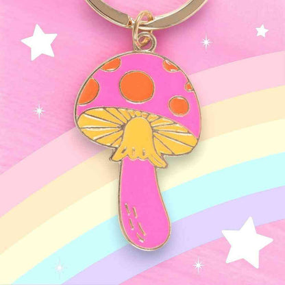 Mushroom keyring charm with pink stem and orange cap spots on a bronze ring