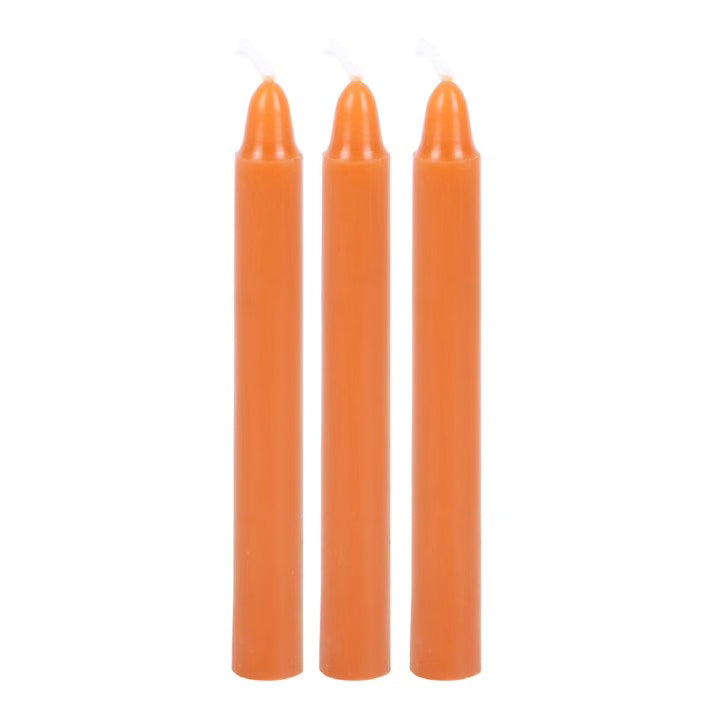 Set of three orange taper candles with smooth cylindrical bodies