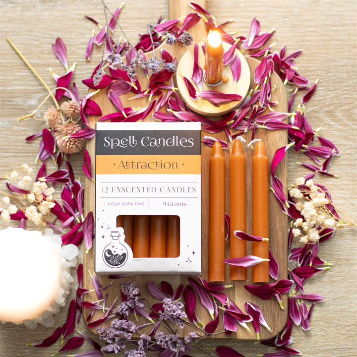 Set of 12 unscented candles with Attraction box and orange candles with lit wicks