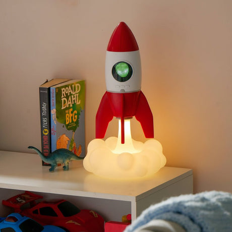 Rocket children’s night light and ceiling projector glowing in bedroom