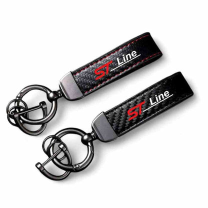 Horseshoe-buckle keychain pair with black carbon-fibre straps and ST Line logo
