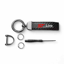 Keychain components: black carbon-fibre strap, rings, horseshoe buckle, tool