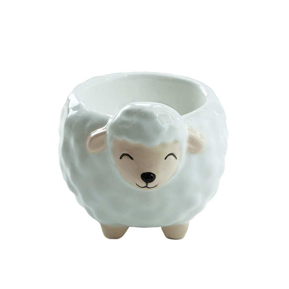 Sheep-shaped ceramic egg cup with painted face and small ears, empty