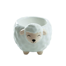 Sheep-shaped ceramic egg cup with painted face and small ears, empty