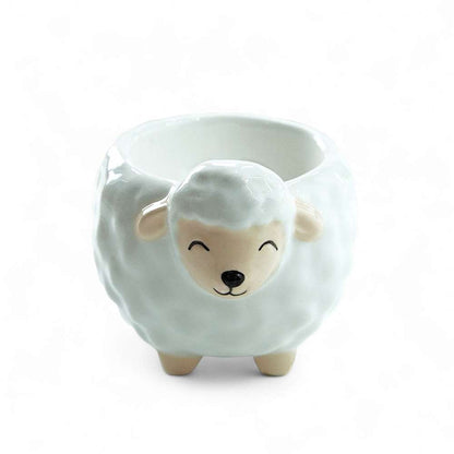 Sheep-shaped ceramic egg cup with front sheep face and open top, empty