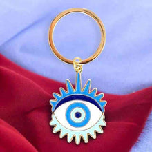 Gold metal keyring with blue enamel evil eye charm