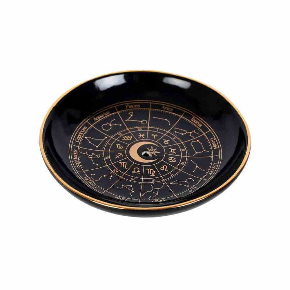 Round black incense holder tray with gold rim and zodiac wheel design.
