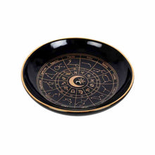 Round black incense holder tray with gold rim and zodiac wheel design.