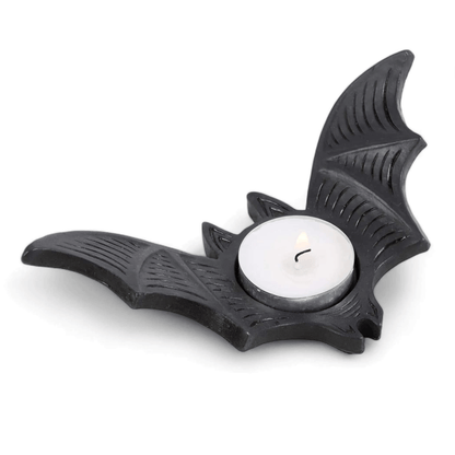 Bat-shaped tealight candle holder with round white candle, black design details.