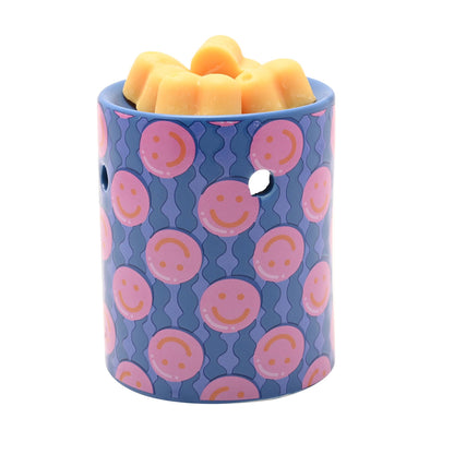 Purple patterned wax melt burner cylinder with yellow wax melts on top.