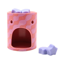 Pink camo wax melt burner with open window and lilac star wax melts, unlit