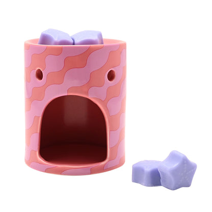 Pink camo wax melt burner with open window and lilac star wax melts, unlit