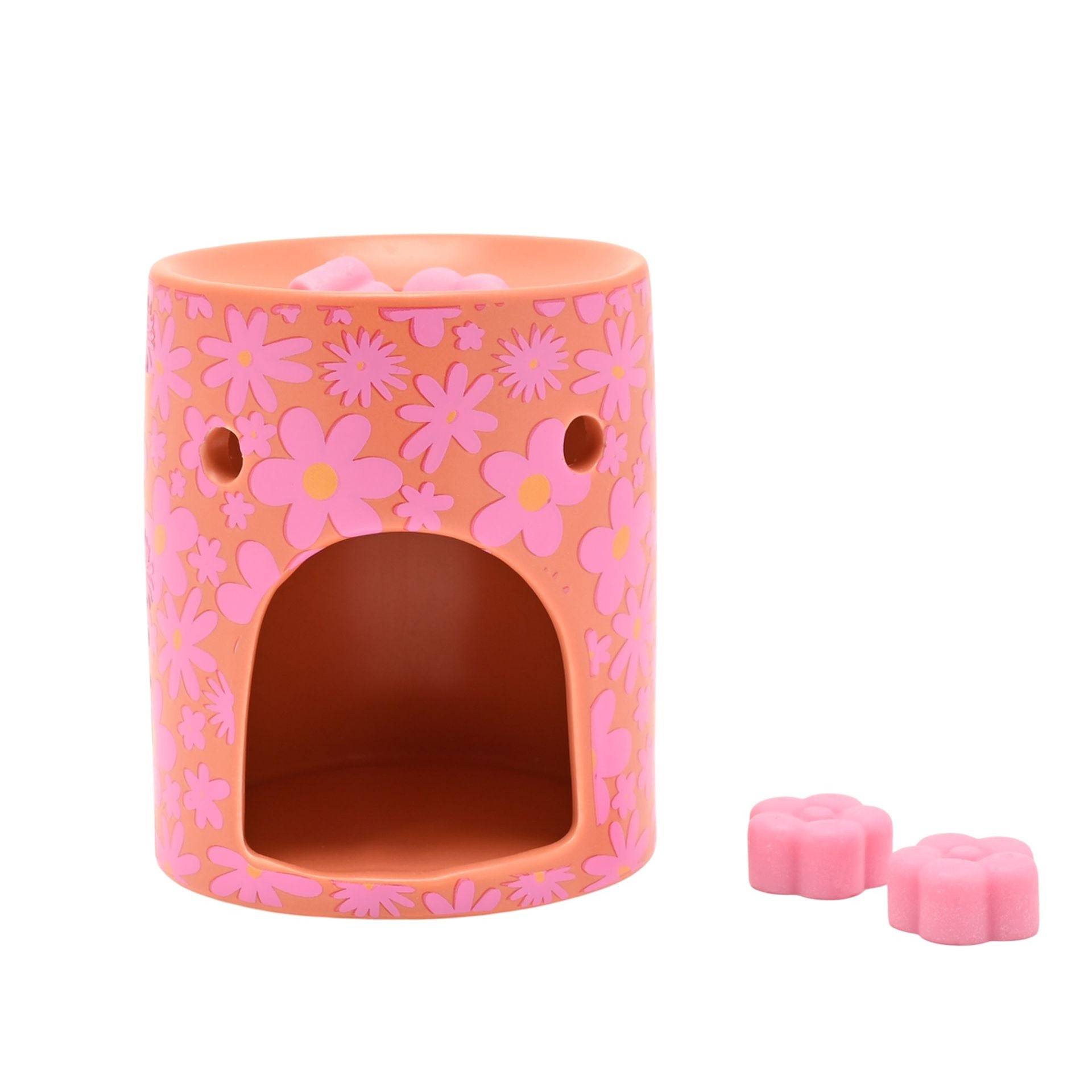Floral wax melt burner with empty cutout and pink wax melt pieces beside it