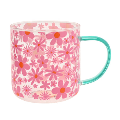 Pink floral glass mug with orange-centered flowers; mint green handle, clear drinking cup.