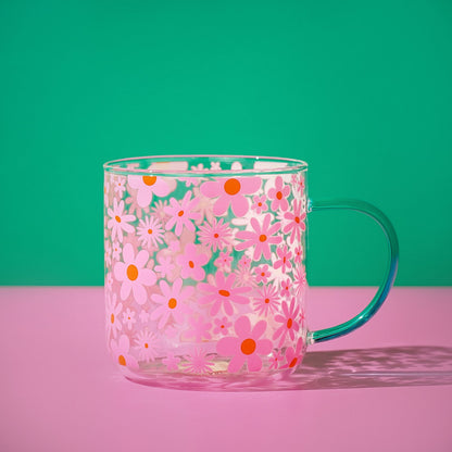 Pink floral glass mug with orange and white blossoms; mint green handle and clear rim.