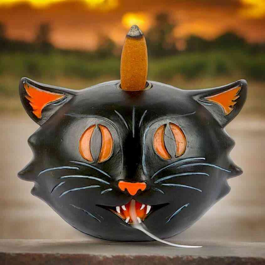 Black cat backflow incense burner with cone, open eyes, and flame slit