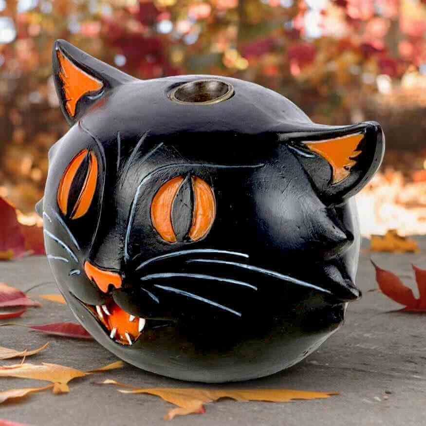 Black cat backflow incense burner with orange-eyed face and top opening for incense