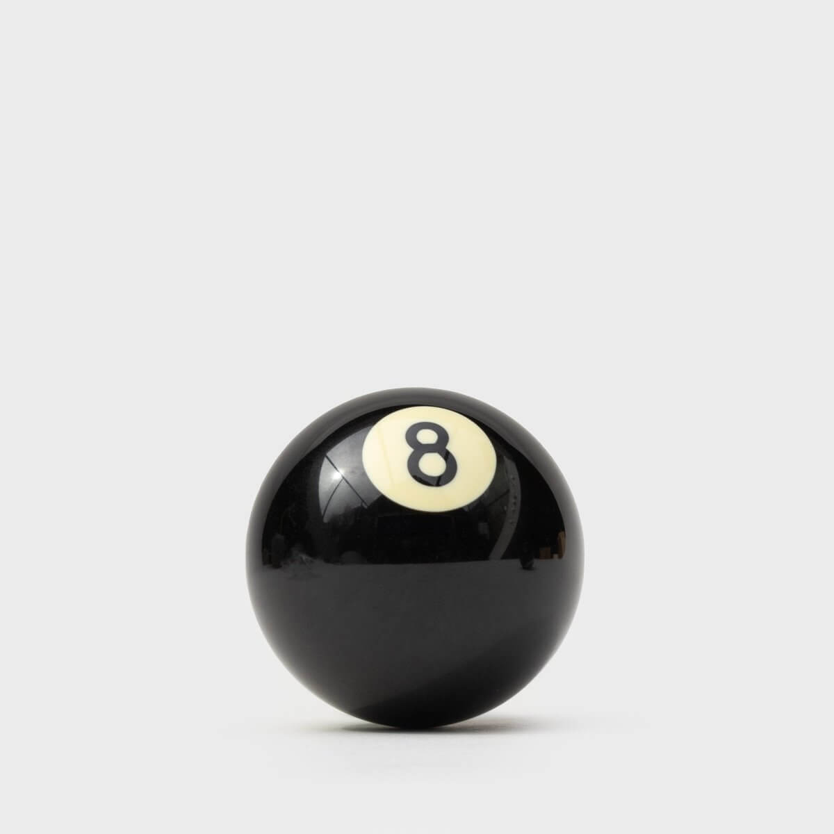 Black 8-ball style bottle opener with white 8 emblem on ball surface