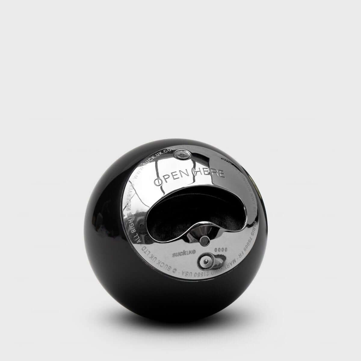 Black 8-ball style bottle opener showing stainless interior opener mechanism