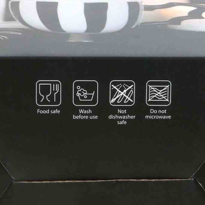 Black teacup set box showing care icons: food safe, wash before use, no dishwasher