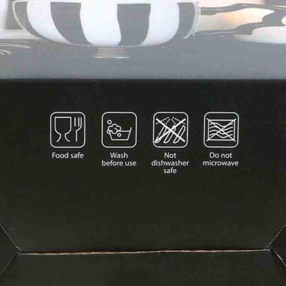 Black teacup set box showing care icons: food safe, wash before use, no dishwasher